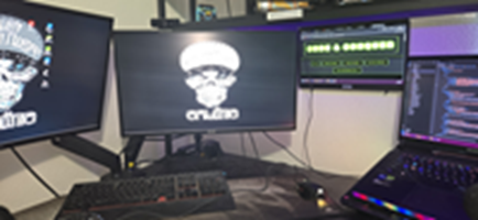 Matthew Gregori streaming setup with multiple monitors and a microphone.